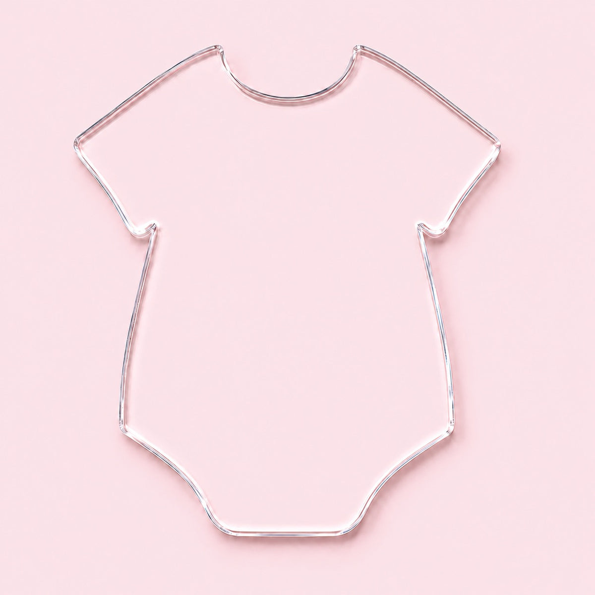 Clear onesie-shaped acrylic blank with no hole, shown on a pink background.