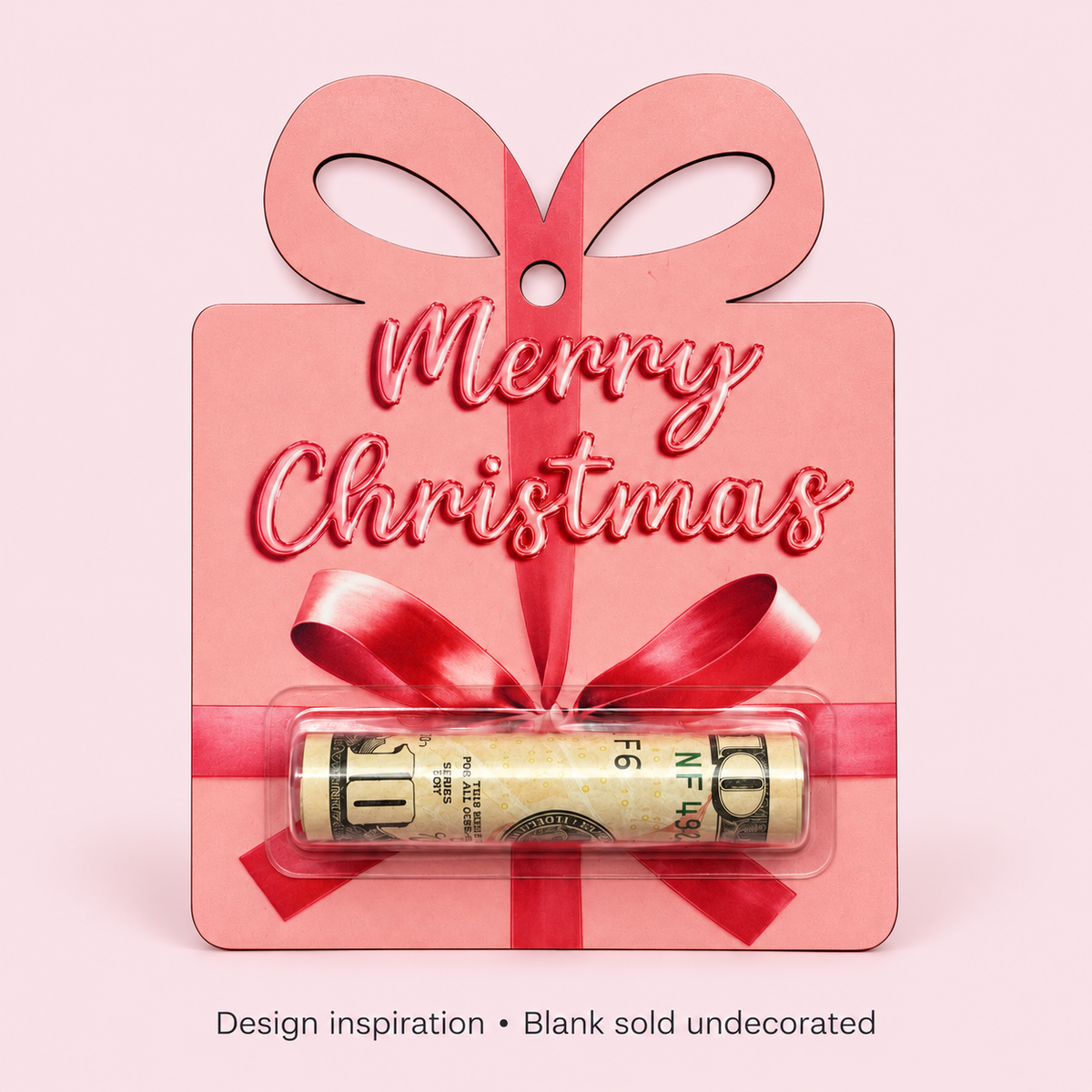 Decorated pink present money holder example with Merry Christmas lettering, a red ribbon design, and rolled cash in a clear dome. Cash not included.